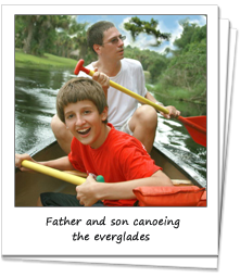 Father and son having fun canoeing through the everglades.
